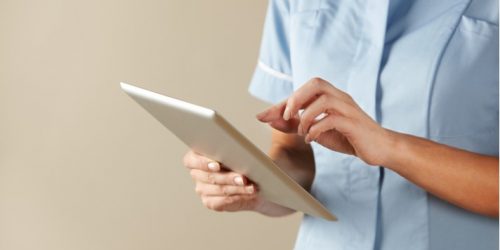 Clinician using tablet in UK hospital