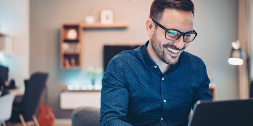 young-man-working-at-home-in-the-evening-picture-id1181035364